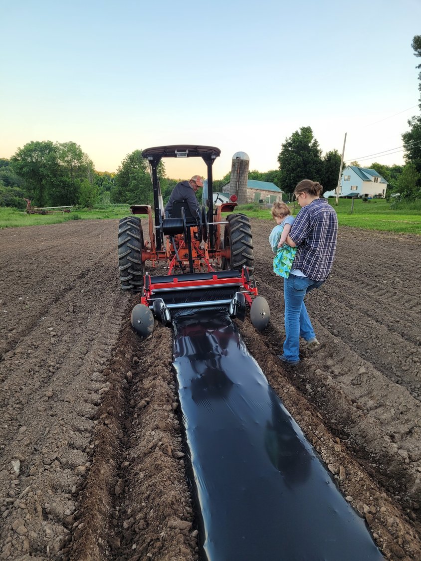 Six-month-old Walker surveys his first planting season with his mommy...
